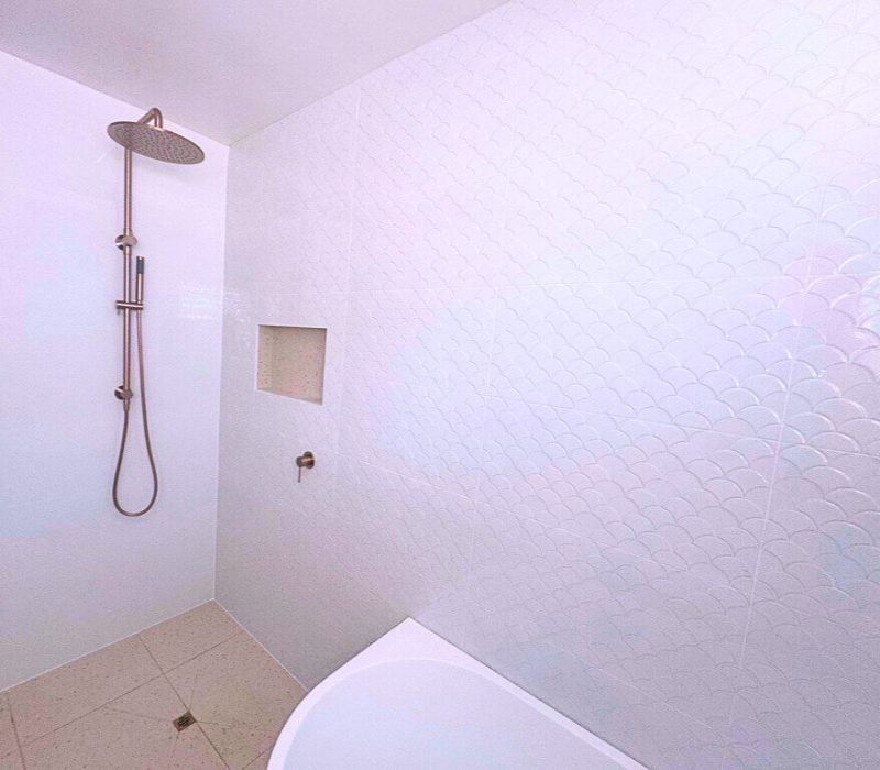 Textured white scallop tile feature wall with rainfall shower