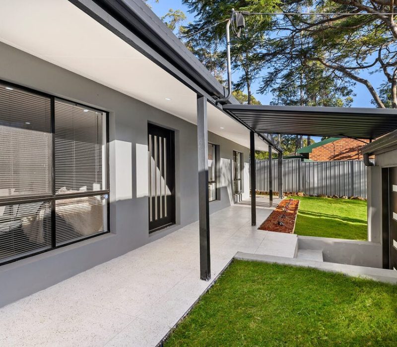 Renovated home entrance with fresh paint and landscaping
