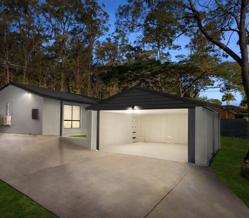 Double garage with rendered finish and driveway lighting