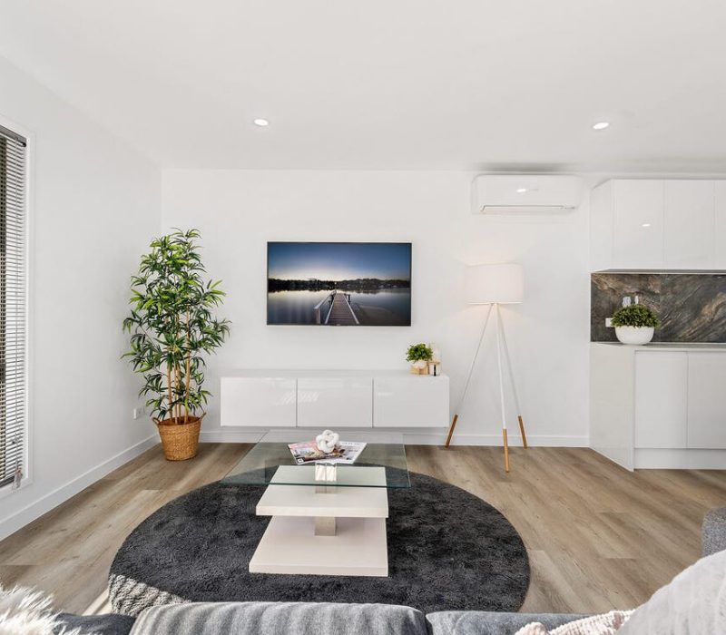 ight-filled living room with modern styling and timber floors