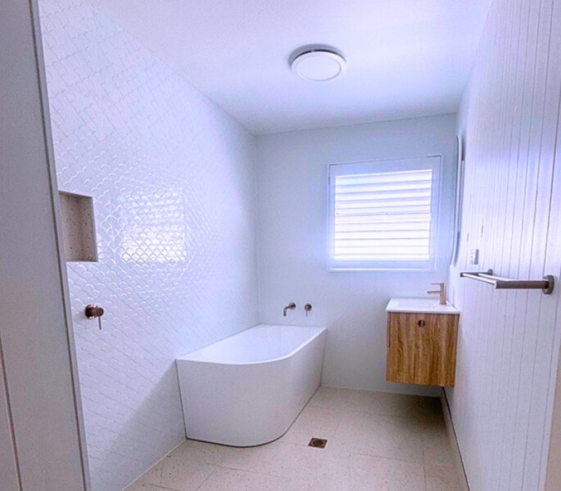 Full bathroom renovation with a floating timber vanity, freestanding bathtub and rainfall shower