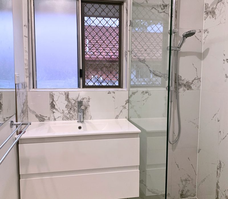 Modern bathroom with marble-look tiles and floating vanity