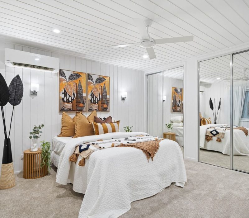 Cosy bedroom with mirrored wardrobes and earthy accent tones