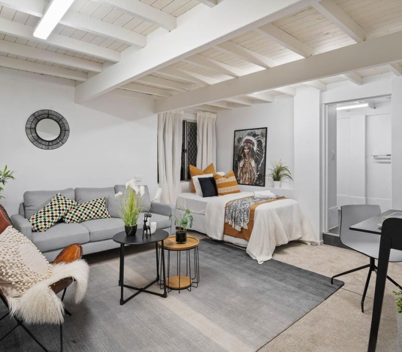 Cosy studio space with exposed beams and styled living area