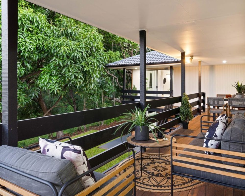 Covered outdoor deck overlooking lush greenery