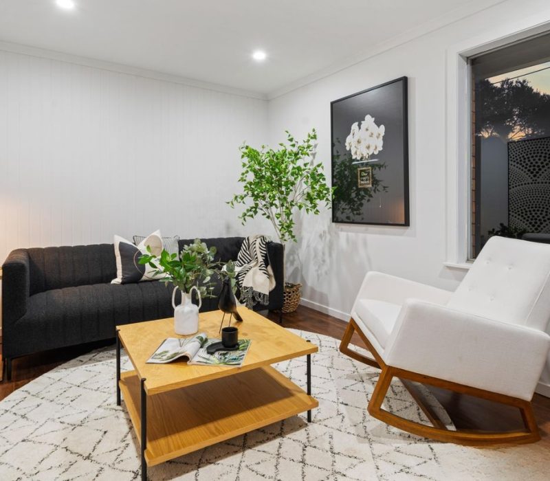 Cosy sitting room with black and white accents and a timber coffee table