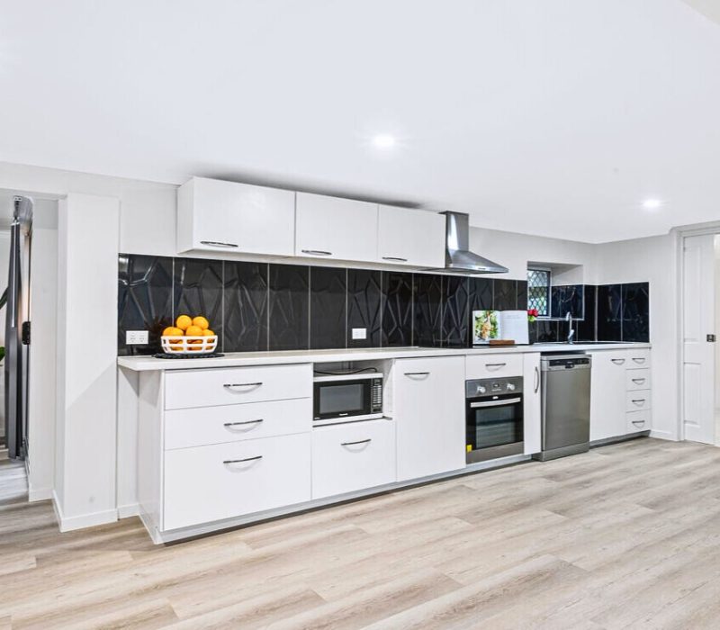 Contemporary kitchen with black textured splashback