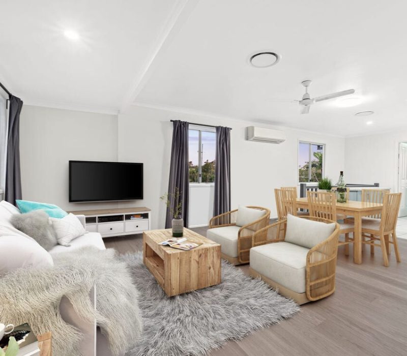 Styled living and dining area with rattan chairs and layered textures