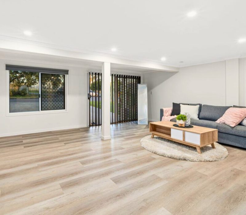 Minimalist living area with large windows and timber floors