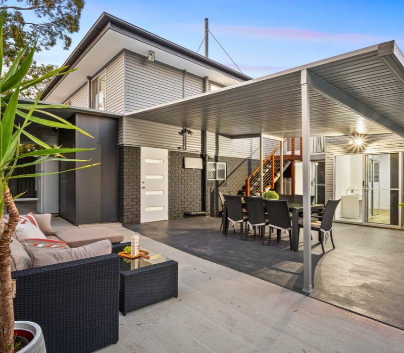 Covered patio with lounge and outdoor dining setup
